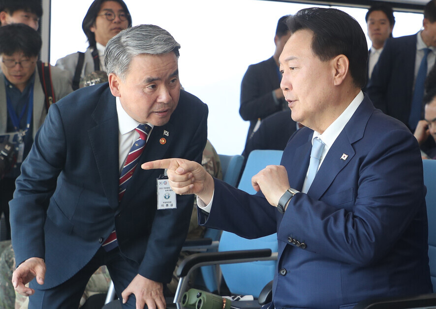 President Yoon Suk-yeol (right) of South Korea speaks to Lee Jong-sup, then the minister of national defense, while observing joint drills in June 2023. (pool photo)