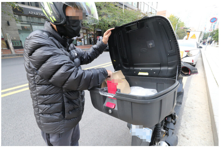 지난해 11월 마포구 용강동에서 한 배달노동자가 배달음식을 오토바이 상자에 담고 있다. 김태형 기자 xogud555@hani.co.kr