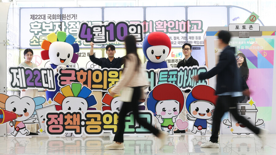 People walk past a display on March 24, 2024, at the Suwon Convention Center in Suwon, Gyeonggi Province, raising awareness about the upcoming general elections on April 10 and getting out the vote. (Yonhap)