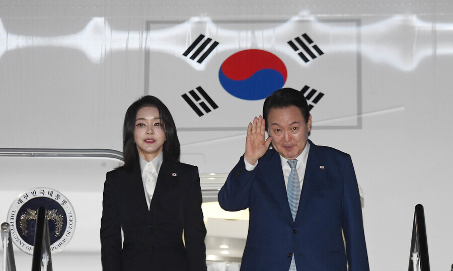 South Korean President Yoon Suk-yeol and first lady Kim Keon-hee wave goodbye as they board the presidential plane in Bali, Indonesia, on Nov. 15 after wrapping up a six-day tour of Southeast Asia. (Yonhap)