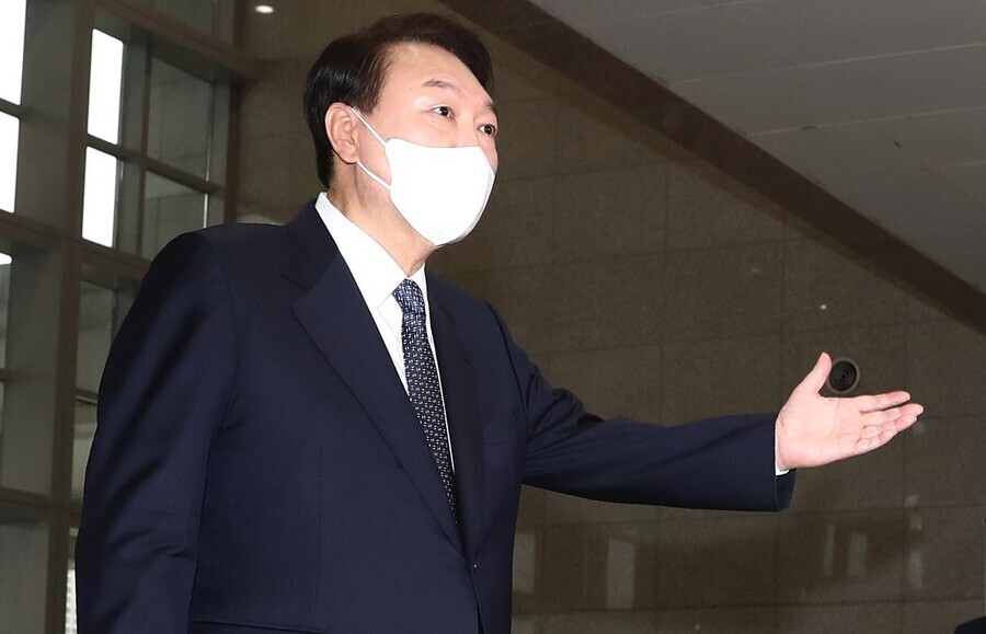 South Korean President Yoon Suk-yeol answers questions from reporters while departing for the presidential office in Seoul’s Yongsan area on Tuesday morning. (presidential office pool photo)