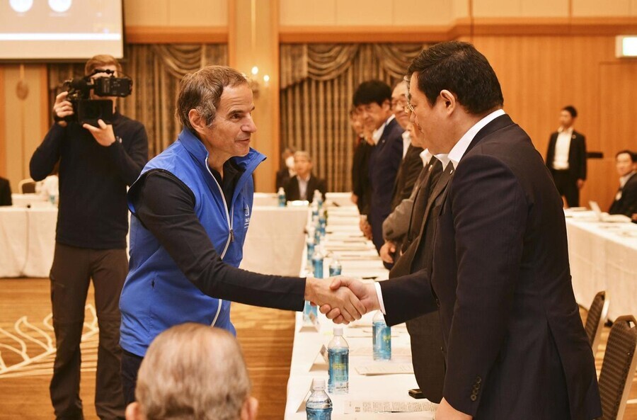 IAEA Director General Rafael Grossi shakes hands with those attending an event regarding the disposal of irradiated water from the Fukushima nuclear power plant held in Japan’s Fukushima Prefecture on July 5. (Yonhap)