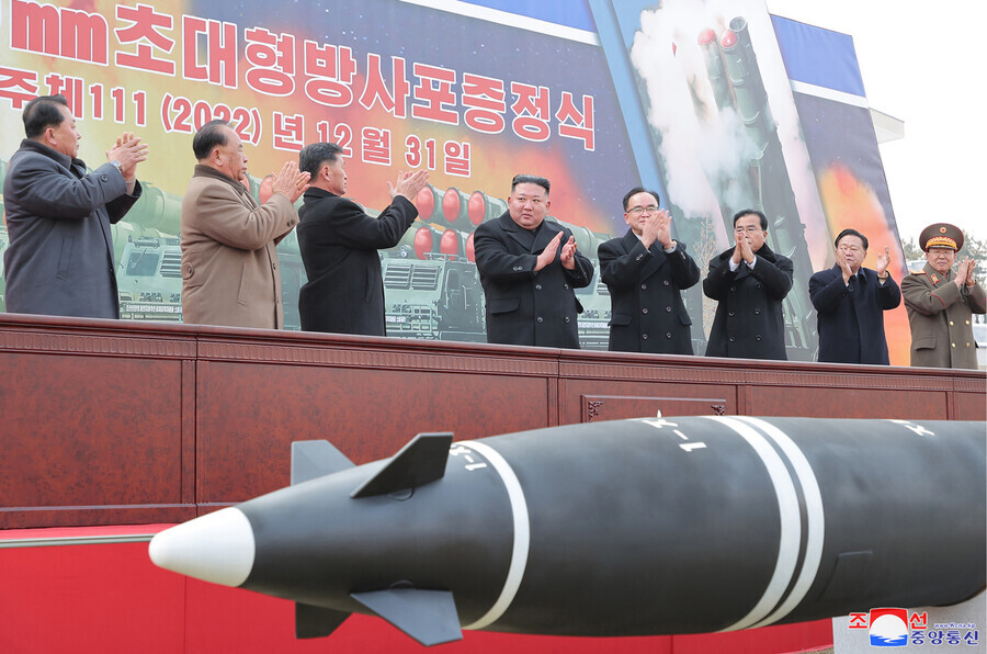 North Korean leader Kim Jong-un applauds at the launch ceremony for the super-large multiple rocket launcher on Dec. 31. (Yonhap)