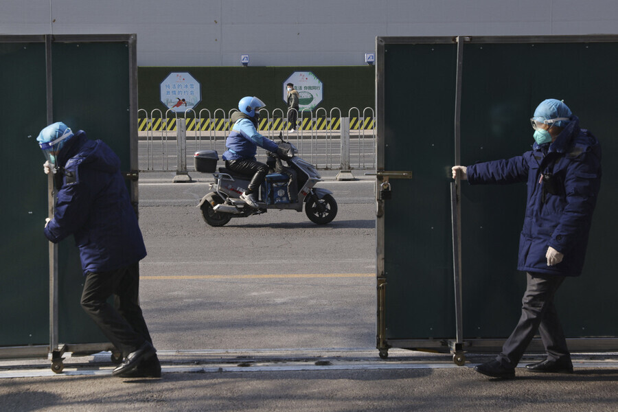Two people open a gate into the closed loop on Feb. 9. (Reuters/Yonhap News)