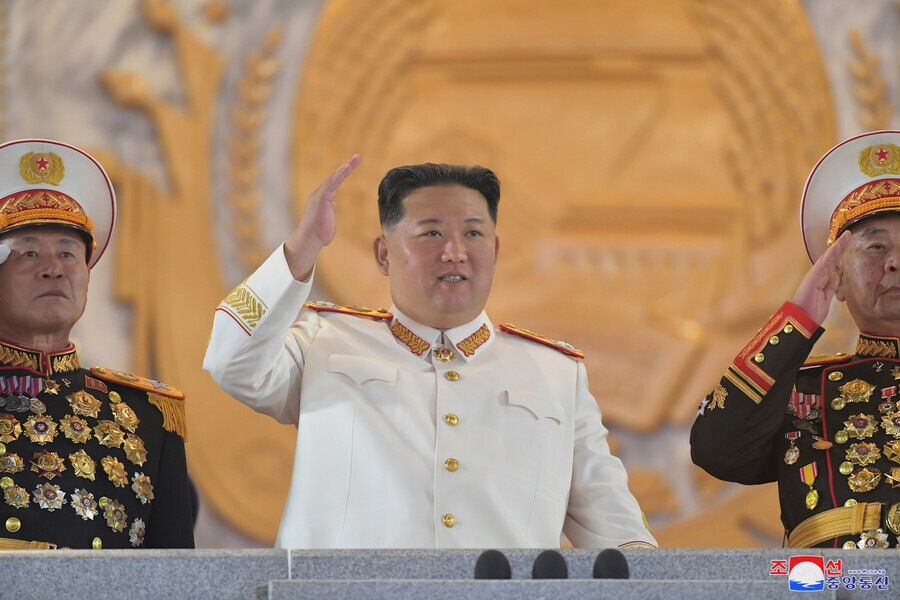 North Korean leader Kim Jong-un waves during a military parade on the 90th anniversary of the establishment of the Korean People’s Revolutionary Army, which was held at Kim Il-sung Square in Pyongyang on the evening of April 25, in this photo released by North Korean state media. (KCNA/Yonhap News)