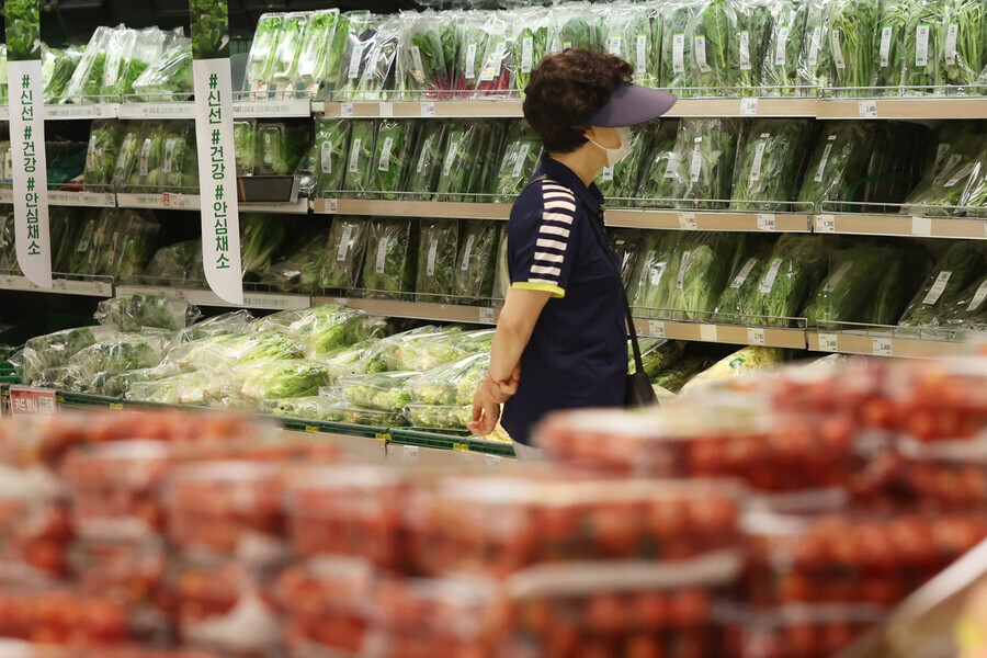 A person peers at produce prices at a supermarket in Seoul on July 4, amid high produce prices. (Yonhap News)