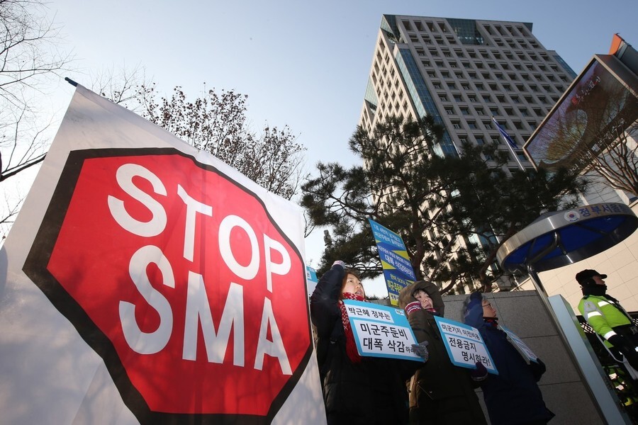 Civic groups chant slogans during a press conference in front of the Ministry of Foreign Affairs in Seoul’s Jongno district