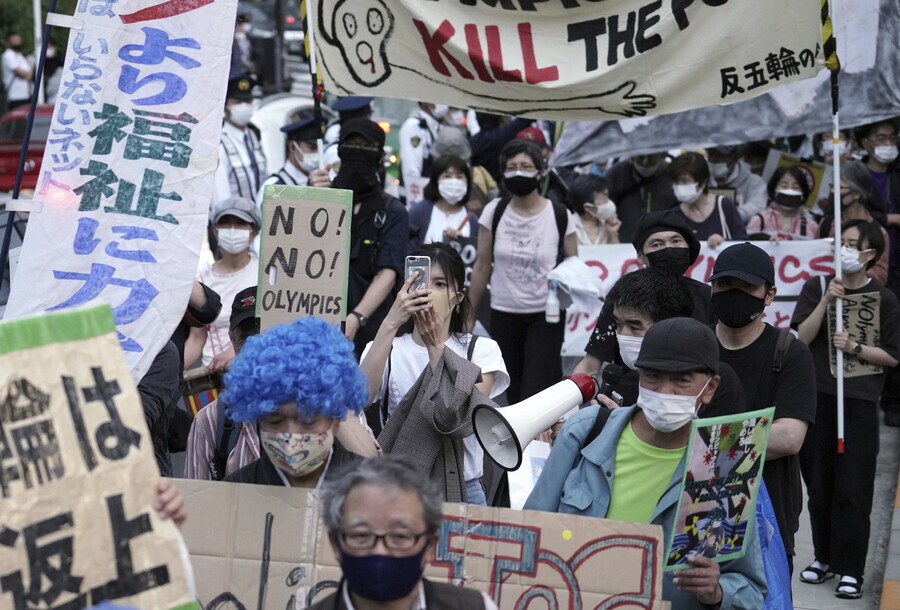 Protesters gather near Japan National Stadium in Shinjuku, Tokyo, on Monday to call for the cancellation of the Tokyo Olympics. (AP/Yonhap News)