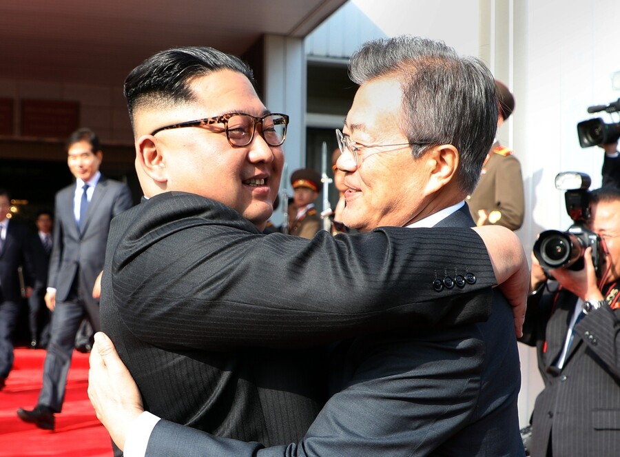 South Korean President Moon Jae-in and North Korean leader Kim Jong-un embrace each other after their surprise summit at Tongilgak