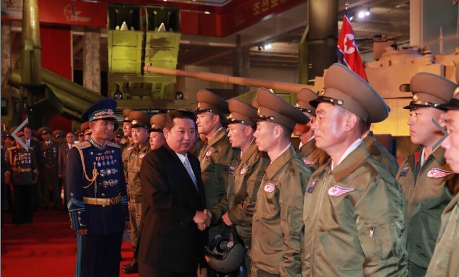 KCNA reported Tuesday that a defense development exhibit had been staged at Pyongyang’s Three Revolutions Exhibition museum on Monday to commemorate the 76th anniversary of the founding of the nation’s ruling party. North Korean leader Kim Jong-un is seen here at the exhibit shaking hands with others in attendance. (KCNA/Yonhap News)