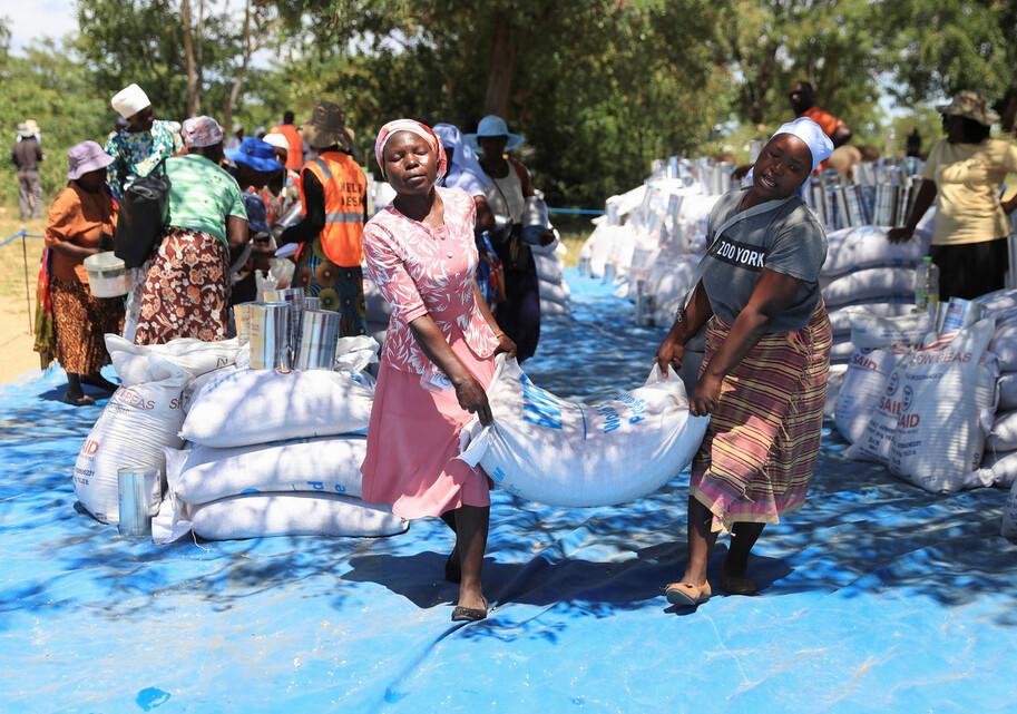 2024년 3월16일 짐바브웨 수도 하라레 외곽의 부헤라 지역에서 마을 주민들이 세계식량기구(WFP)가 마련한 원조 식량을 배급받고 있다. 로이터