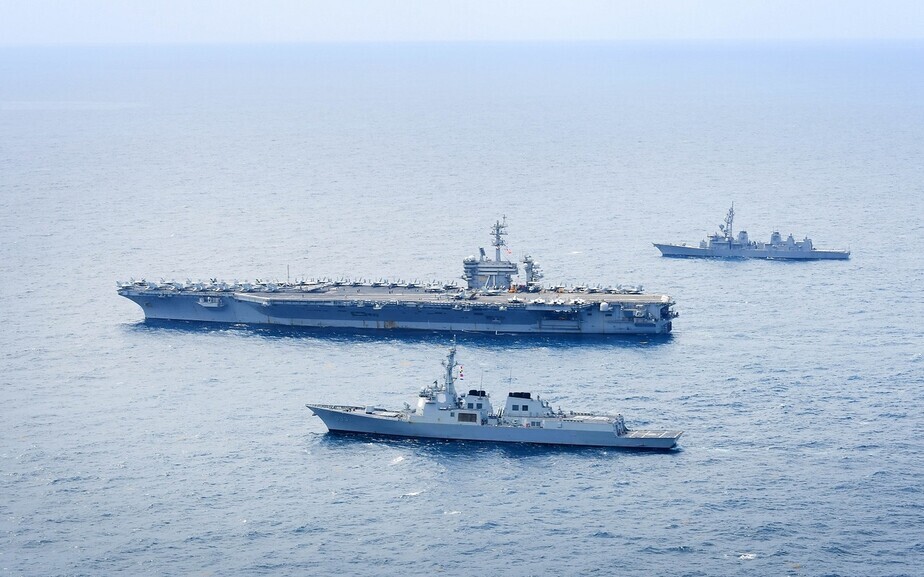 The South Korean Aegis-equipped destroyer Seoae Ryu Seong-ryong (bottom), the USS Theodore Roosevelt and the Japanese destroyer Ariake conduct a joint drill in the waters off South Korea's Jeju Island, on April 11, 2024. (Yonhap)