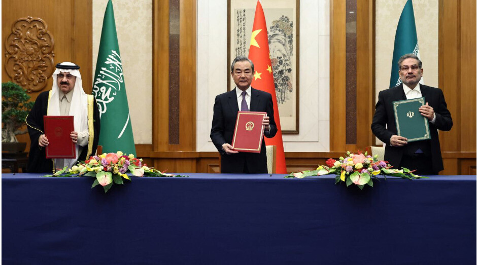 From left to right, Saudi national security advisor Musaad bin Mohammed Al Aiban, Wang Yi of China, and Secretary Ali Shamkhani of the Iranian Supreme National Security Council pose for a photo following a deal inked in Beijing China. (China Daily/Yonhap)