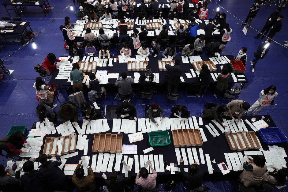 지난 15일 오후 서울 종로구 경복고등학교에 마련된 투표소에서 개표요원들이 비례정당 투표용지를 수개표 하고 있다. 연합뉴스