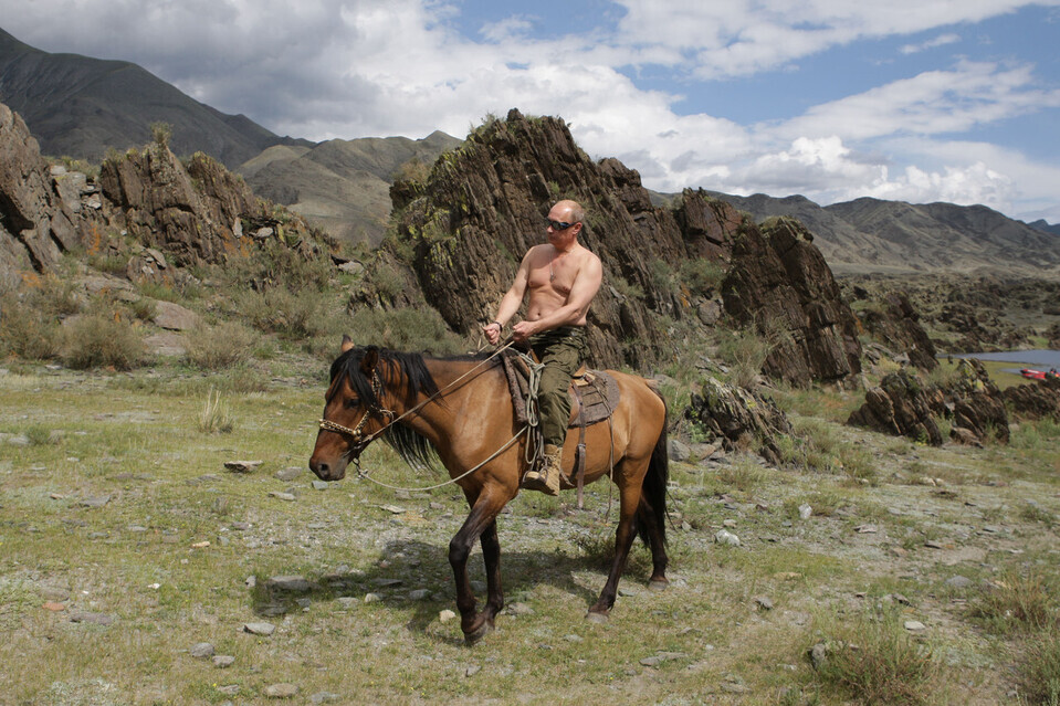 While serving as prime minister in August 2009, Vladimir Putin released photos of himself writing horses topless, evincing an image of a strong Russia. (AP/Yonhap)