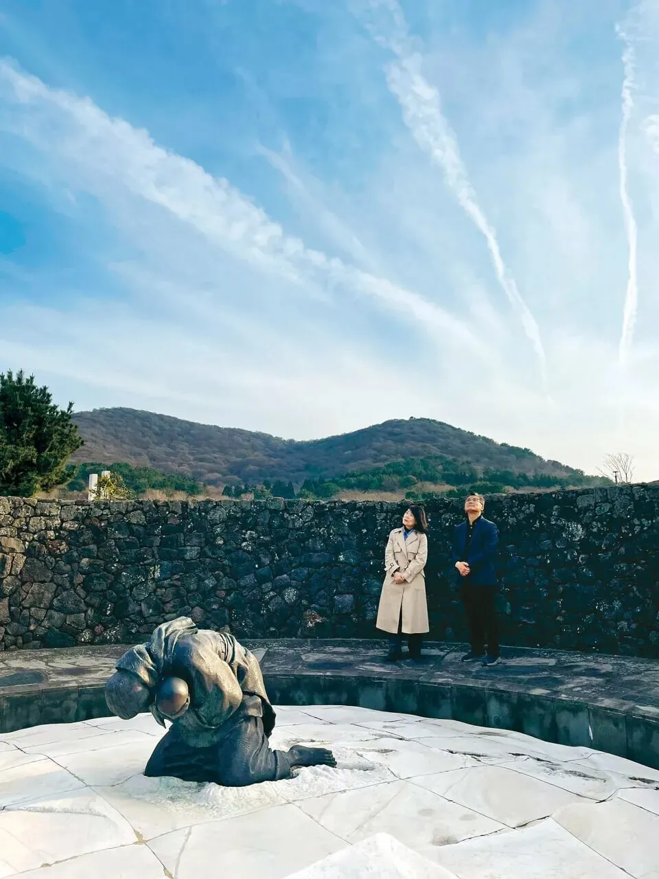 Heo Ho-joon and Heo Young-sun pause for a moment at a sculpture titled &ldquo;Biseol&rdquo; at Jeju 4&middot;3 Peace Park honoring a woman named Byeon Byeong-ok and her daughter, who died during the Jeju April 3 Incident. (Lee You-jin/Hankyoreh)