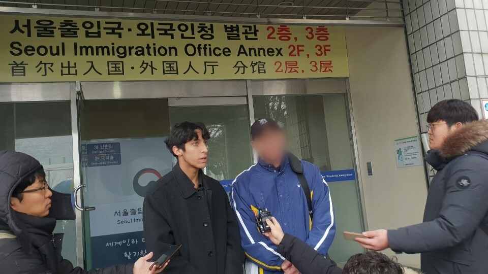 Kim Min-hyeok calls for a reappraisal of his father’s refugee application in front of the Seoul Immigration Office on Feb. 19. (Lee Jung-gyu