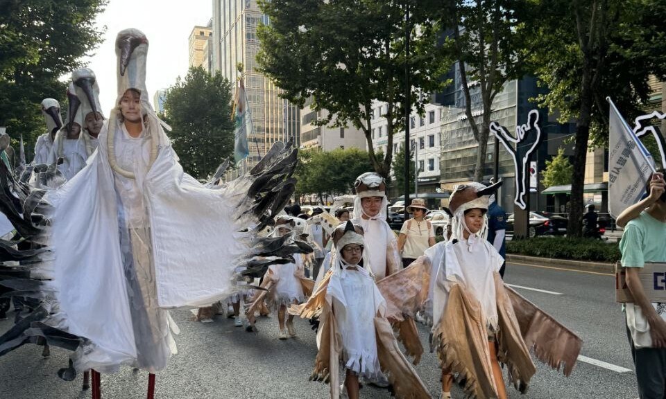 Young people from the Yeongju and Sangju regions of North Gyeongsang Province dressed long-billed plovers, an endangered wildlife class in Korea, walk down the streets near Gangnam Station in Seoul as part of the 907 Climate Justice March on Sept. 7, 2024. (courtesy of the Namoodak Movement Lab)