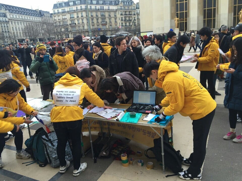 Members of Hope Butterfly collect signatures in front of the Eiffel Tower in Paris on Jan. 1