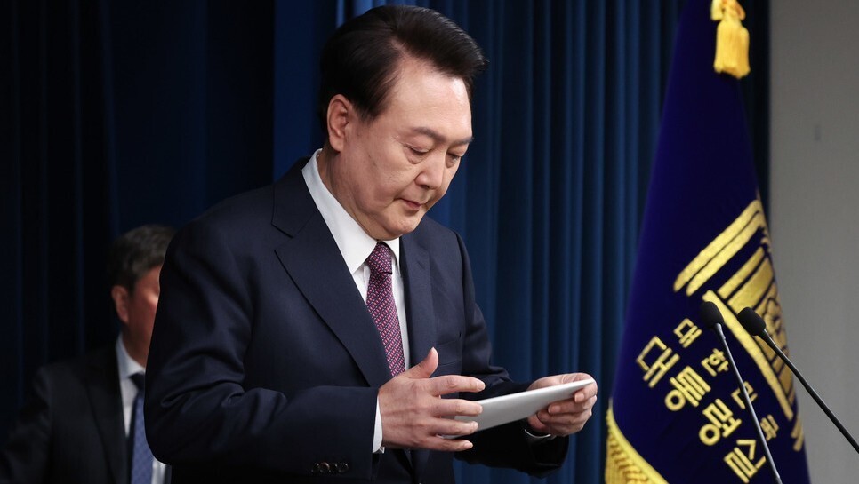 President Yoon Suk-yeol looks at his notes ahead of delivering an apology to the Korean people from the presidential office in Yongsan, Seoul, after Busan failed in its bid to win the World Expo 2030. (Yonhap)