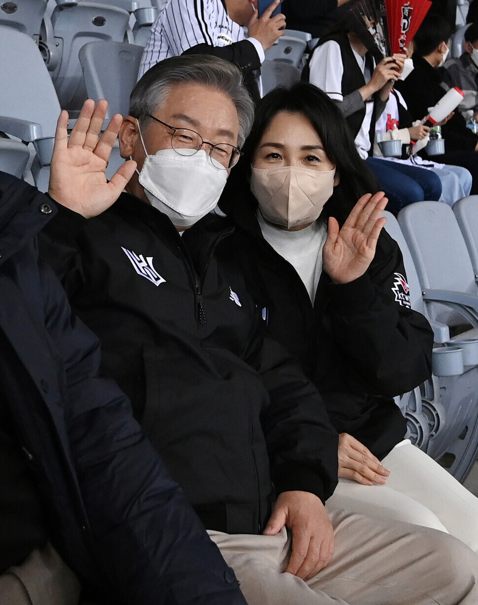 Democratic Party presidential nominee Lee Jae-myung and his wife Kim Hye-gyeong sit in the stands at Game 4 of the 2021 SOL KBO League Korean Series on Nov. 18. (pool photo)