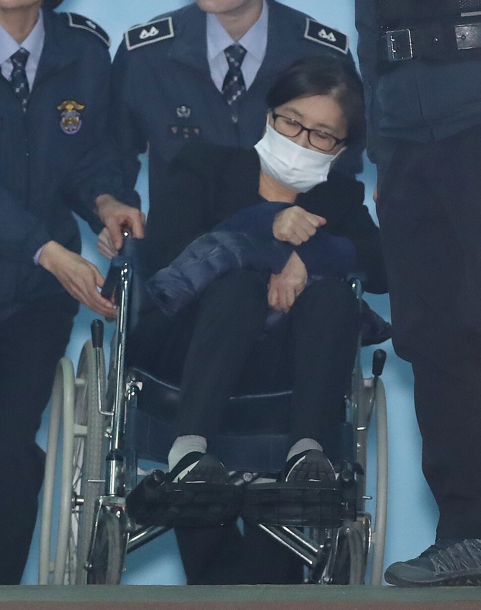 Choi Soon-sil is wheeled out of the courtroom in the Seoul Central District Court on Dec. 14. Prosecutors are asking for a sentence of 25 years in prison