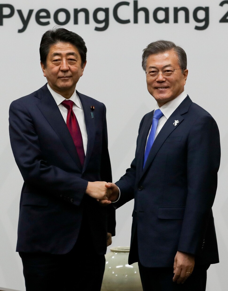 President Moon Jae-in shakes hands with Japanese Prime Minister Shinzo Abe prior to their summit at the Blisshill Stay at Yongpyong Resort in Pyeongchang County