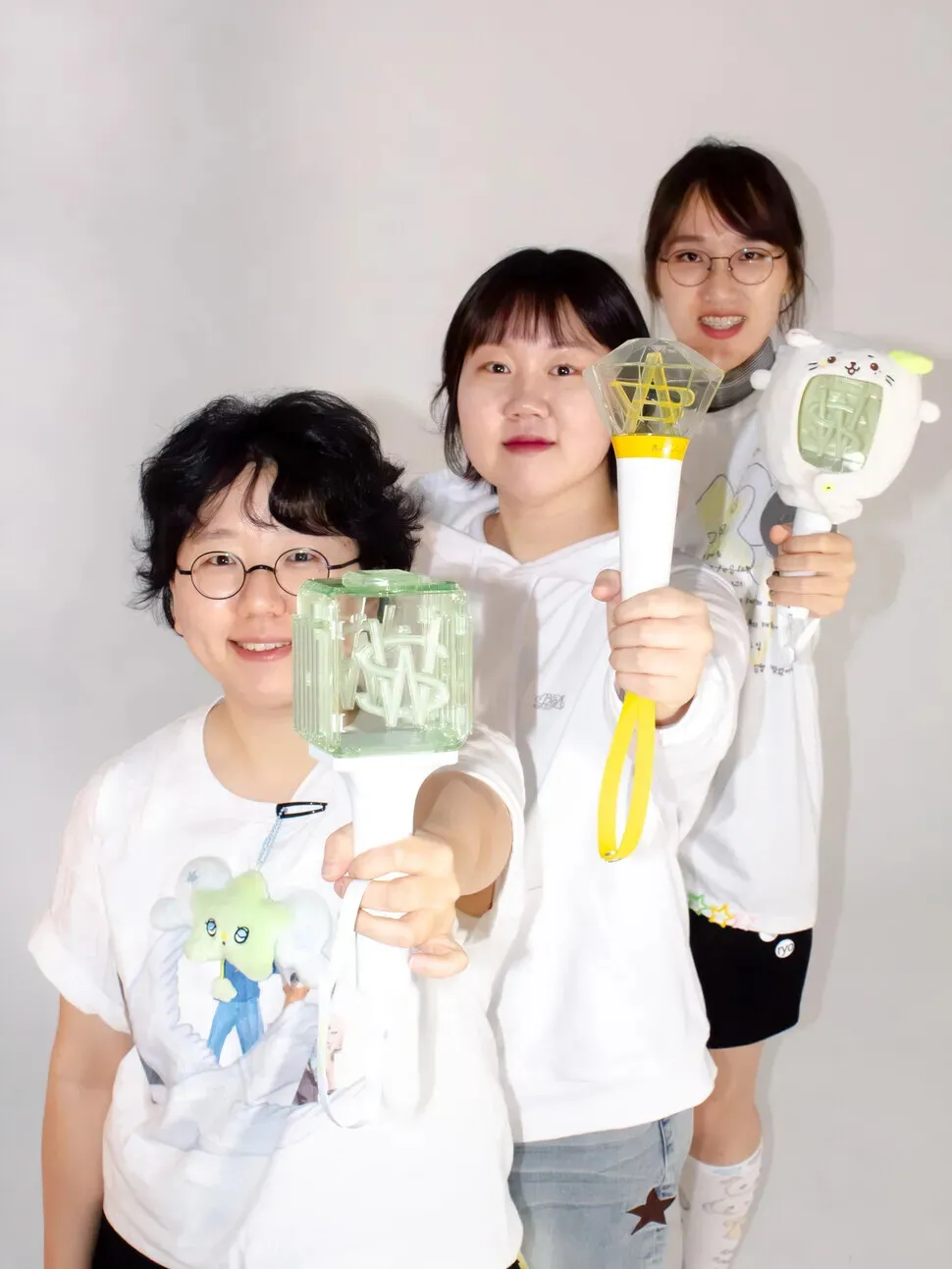 Gugu, Ilseok, and Hee-ju were three K-pop fans who took to the streets to call for Yoon’s impeachment with lightsticks in hand. The three women later published a book of interviews with K-pop fans who took part in the protests. (courtesy of Clayhouse)