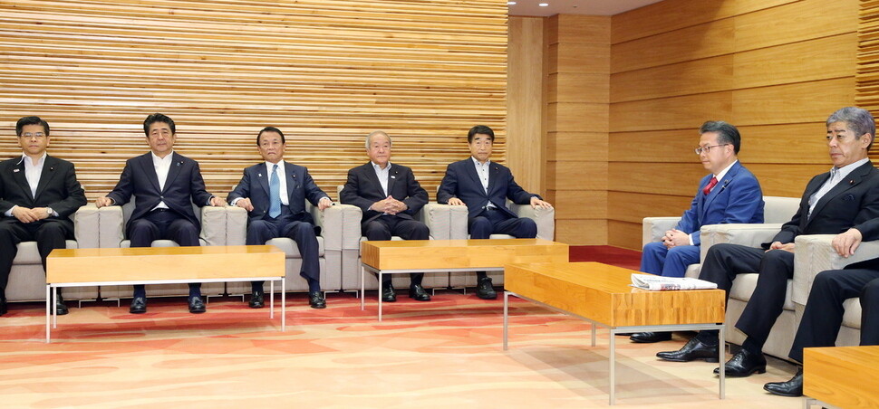 Japanese Prime Minister Shinzo Abe (second from left) and Minister of Economy