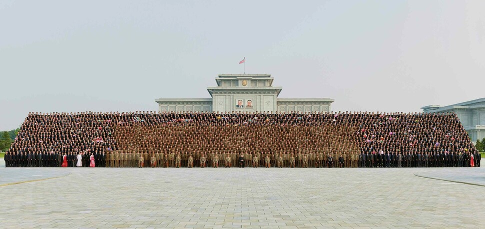 North Korean leader Kim Jong-un takes a commemorative photo of the people who participated in the successful launch of a Hwasong-14 missiles