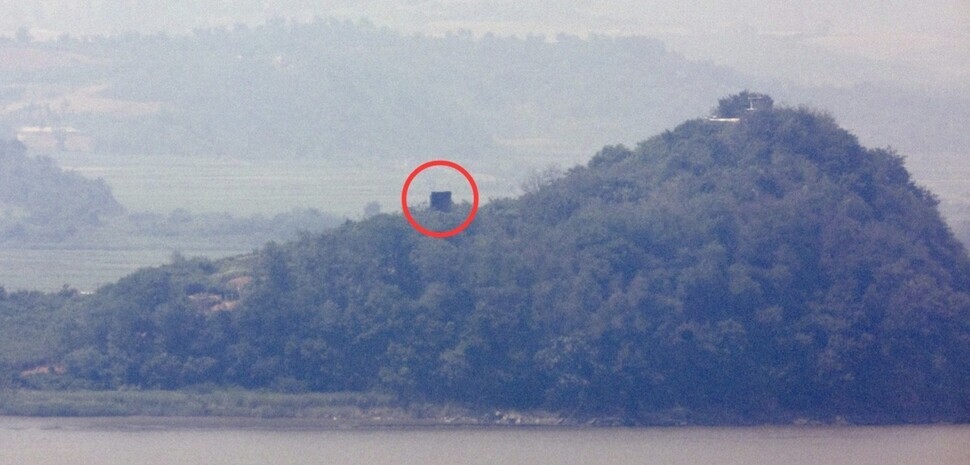 Military installations believed to be loudspeakers (circled) near a guard post on the North Korean side of the inter-Korean border along the Imjin River, as seen from the South’s Odusan Unification Tower on June 11, 2024. (Yonhap)