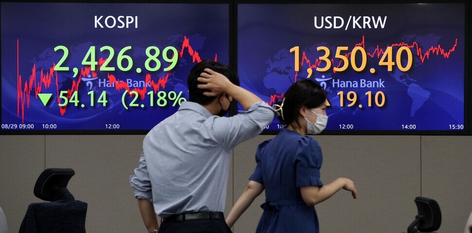 Monitors in the KEB Hana Bank dealing room in downtown Seoul show the KOSPI and won-dollar exchange rate on Aug. 29. (Kim Bong-gyu/The Hankyoreh)