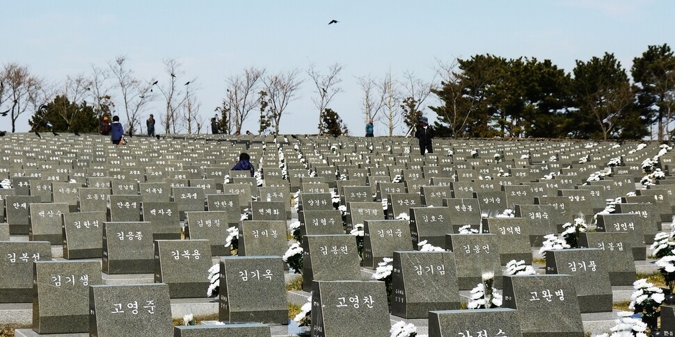 Families of Jeju island residents killed during the April 3 Massacre walk through the Jeju City Peace Park past headstones marked “unknown” on the 69th Anniversary of the incident. Over 30