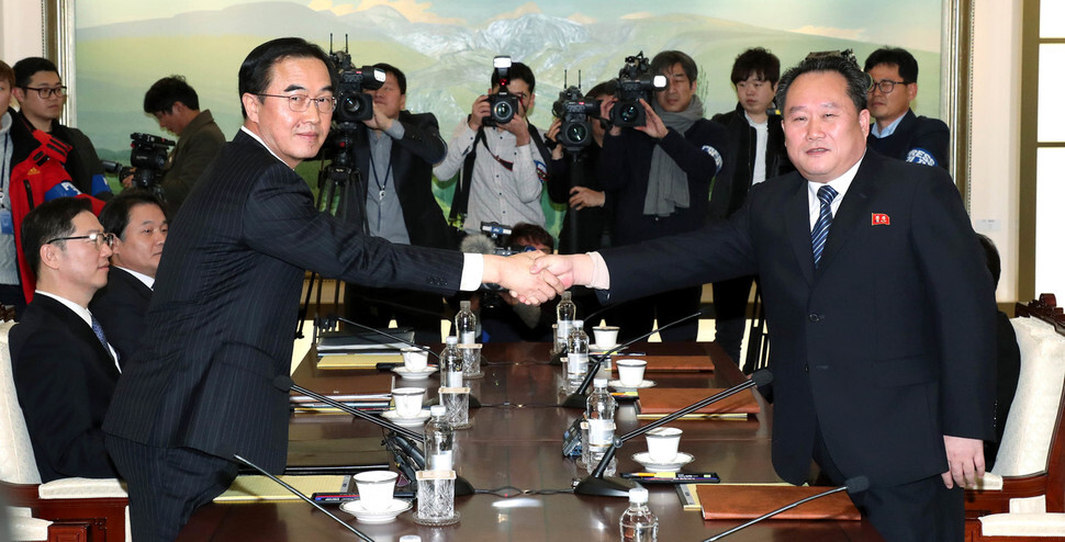 Unification Minister Cho Myong-gyon shakes hands with Ri Son-gwon