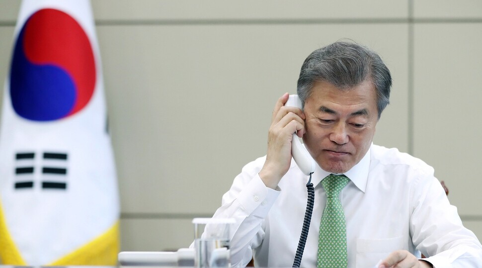 South Korean President Moon Jae-in talks with Chinese President Xi Jinping on the telephone in the Blue House on May 4.