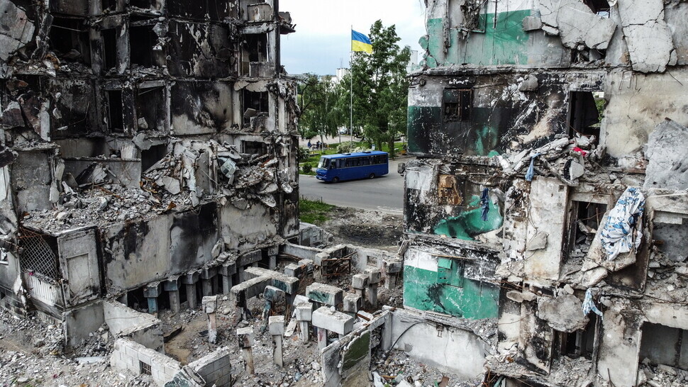 A Ukrainian flag flies in the background of the ruins of a building in Borodyanka, a small city outside of Ukraine’s capital of Kyiv, that was hit by Russian fire. (EPA/Yonhap News)