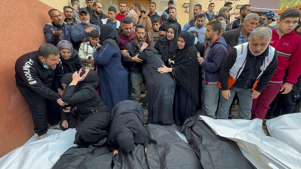 Palestinians gather around the bodies of those killed in airstrikes by Israel outside Nasser Hospital in Khan Younis in southern Gaza on Dec. 20, 2023. (Reuters)