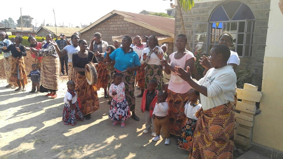 아프리카 전통 리듬의 춤사위 속에 스와힐리어로 환영의 노래를 부르며 한국컴패션 후원자들을 맞는 젊은 엄마들과 아이들. 이들은 카왕과레의 한 컴패션 어린이센터를 통해 ‘태아·영아 생존 프로그램’의 관리를 받고 있다. 이 중에는 무상 치료와 관리를 받는 HIV 보균자들도 있다.