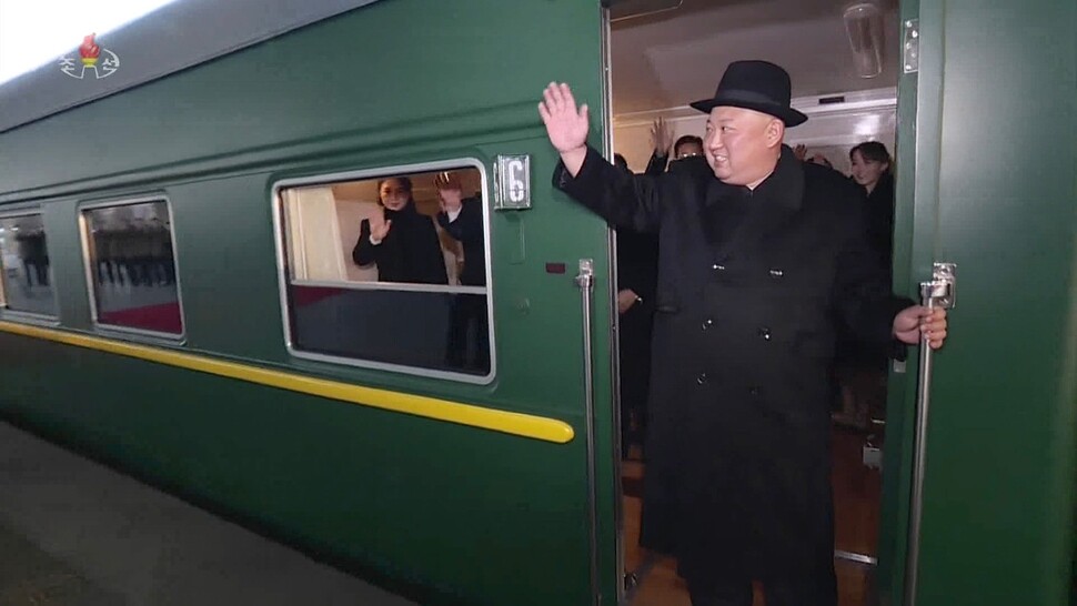 North Korean leader Kim Jong-un and first lady Ri Sol-ju prepare to board a special train bound for China in Pyongyang on Jan. 7. The scene was broadcasted by Korea Central Television (KCTV) on Jan. 8. (KCTV/Yonhap News)