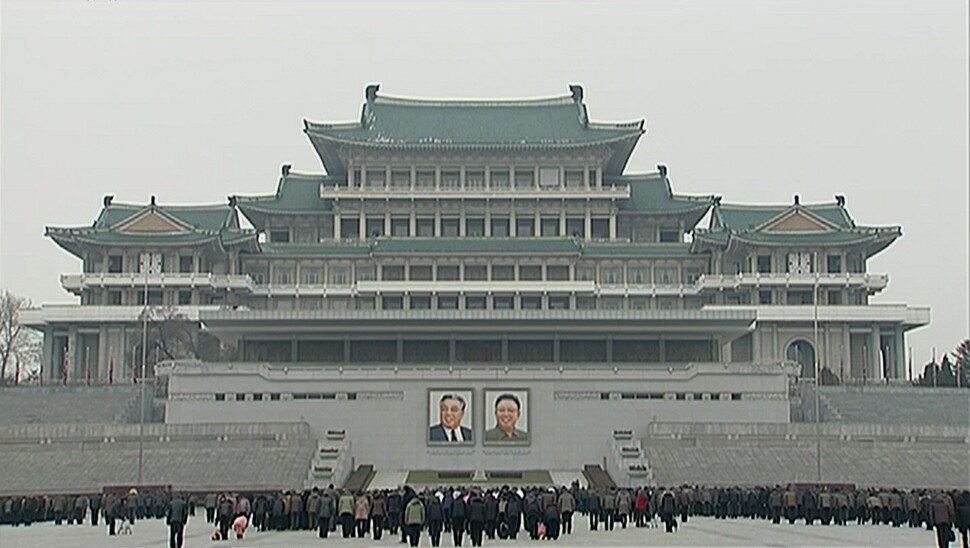 Residents of Pyongyang bow during three minutes of silence and stopped traffic near Kim Il-sung Square on Dec. 17