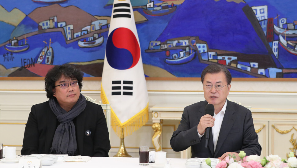 South Korean President Moon Jae-in delivers congratulatory remarks to filmmaker Bong Joon-ho during a Blue House luncheon with the cast of “Parasite” on Feb. 20. (Kim Jung-hyo, staff photographer)