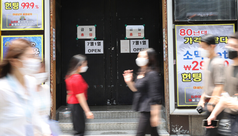 A nightlife venue in Seoul, pictured on Monday, has signs on its doors that say “July 1 OPEN” since nightlife venues will be allowed to reopen on July 1 under the revised distancing rules. (Yonhap News)