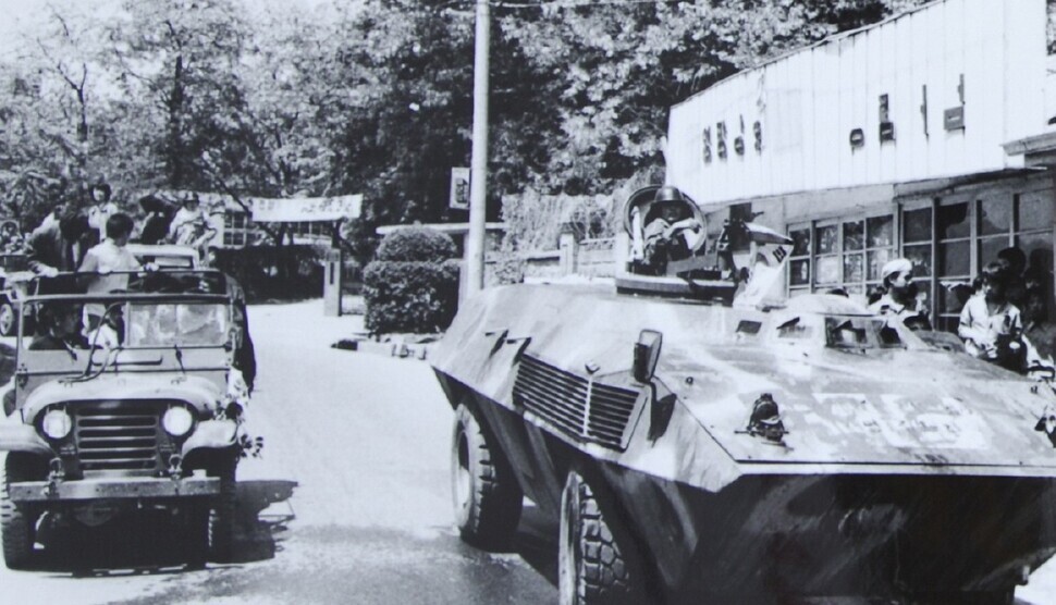 Members of Gwangju’s citizens militia drive a commandeered Jeep and armored car through the Yangnim neighborhood of Gwangju’s Nam (South) District during the May 1980 uprising in the city. (from the Defense Security Demand photo archive)
