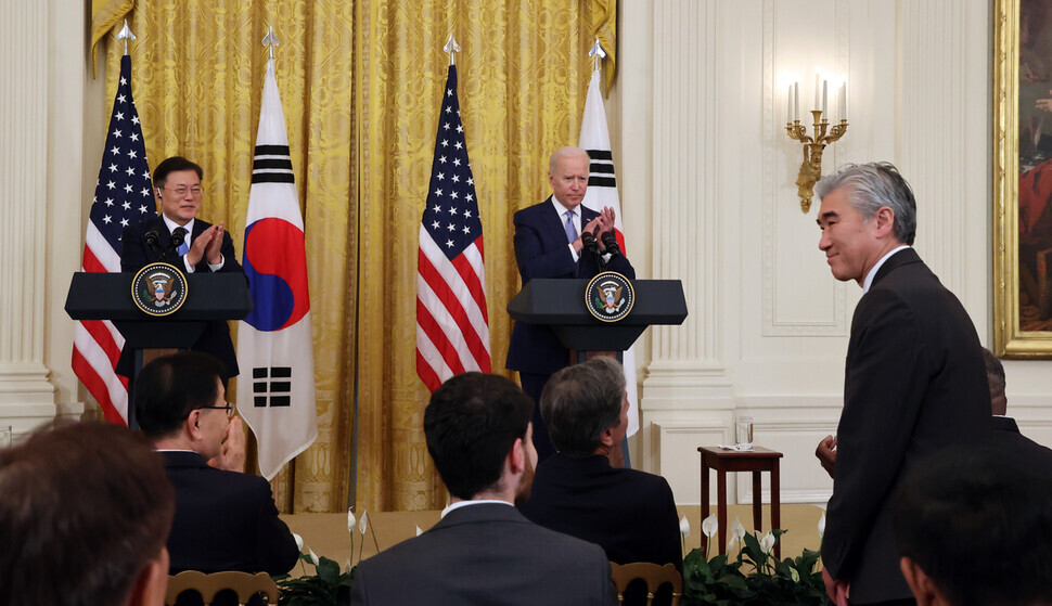 Then-acting US Assistant Secretary of State for East Asian and Pacific Affairs Sung Kim (right) stands up as US President Joe Biden announces him as the US State Department’s new special representative for North Korea during a joint press conference at the South Korea-US summit at the White House on May 21. (Yonhap News)