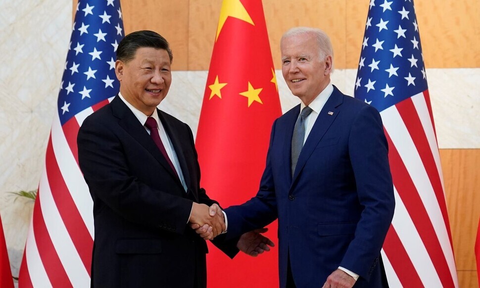 President Xi Jinping of China shakes hands with US President Joe Biden on Nov. 14 after their first in-person summit in Bali. (Reuters/Yonhap)