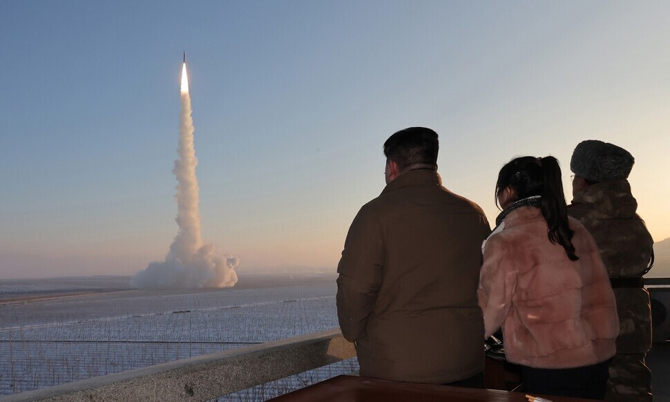 This photo, released by North Korean state media, shows North Korean leader Kim Jong-un joined by his daughter, Kim Ju-ae, as he watches the launch of the Hwasong-18 solid-fuel ICBM on Dec. 18, 2023. (KCNA/Yonhap)