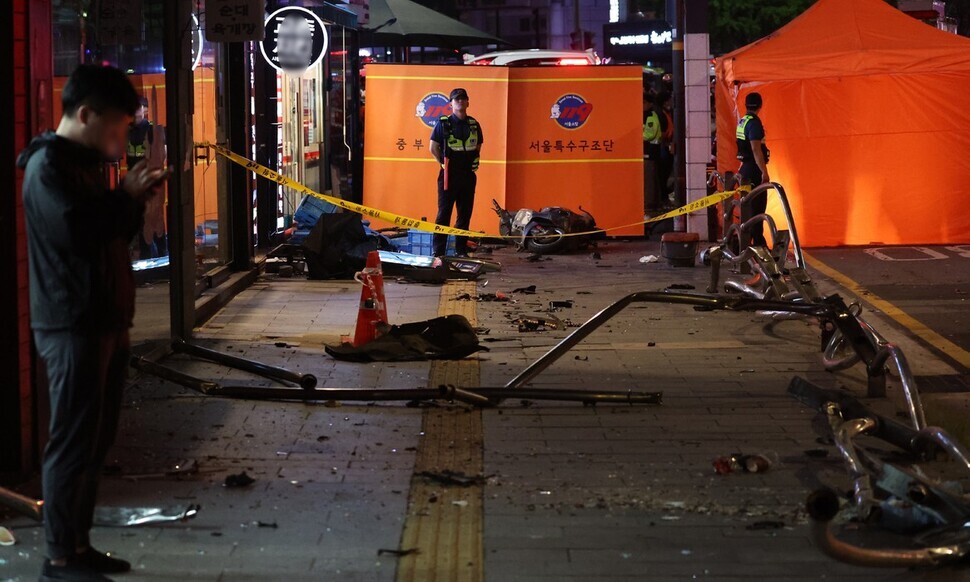 Debris is scattered across a sidewalk near City Hall Station in Seoul after a car crashed through the barricade, killing at least nine, on July 1, 2024. (Yonhap)
