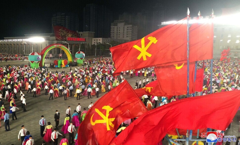 North Koreans can be seen celebrating the 76th anniversary of the founding of the WPK in Kim Il-sung Square on Sunday evening. (KCNA/Yonhap News)
