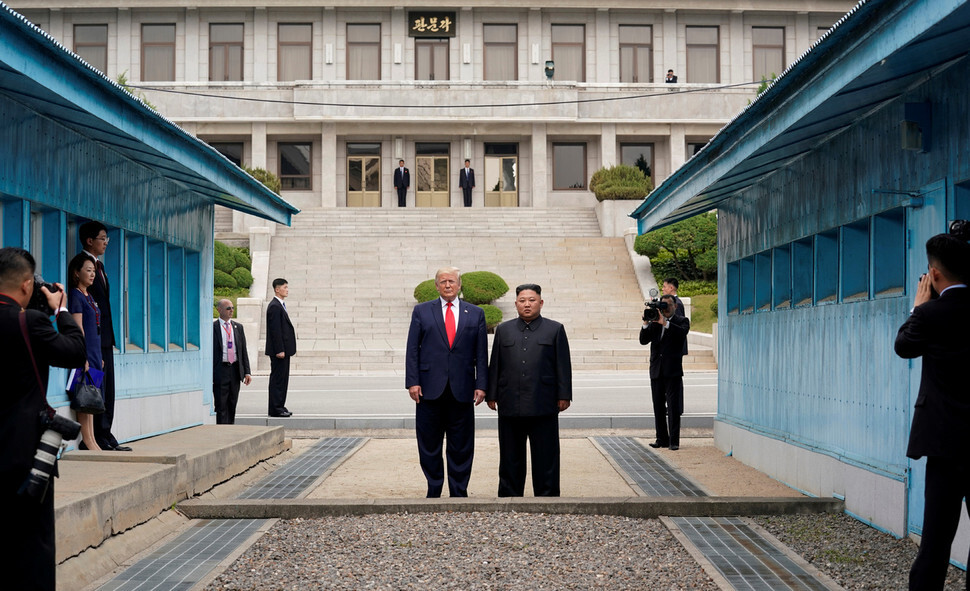 North Korean leader Kim Jong-un and US President Donald Trump stand together at the military demarcation line (MDL) at Panmunjom on June 30.