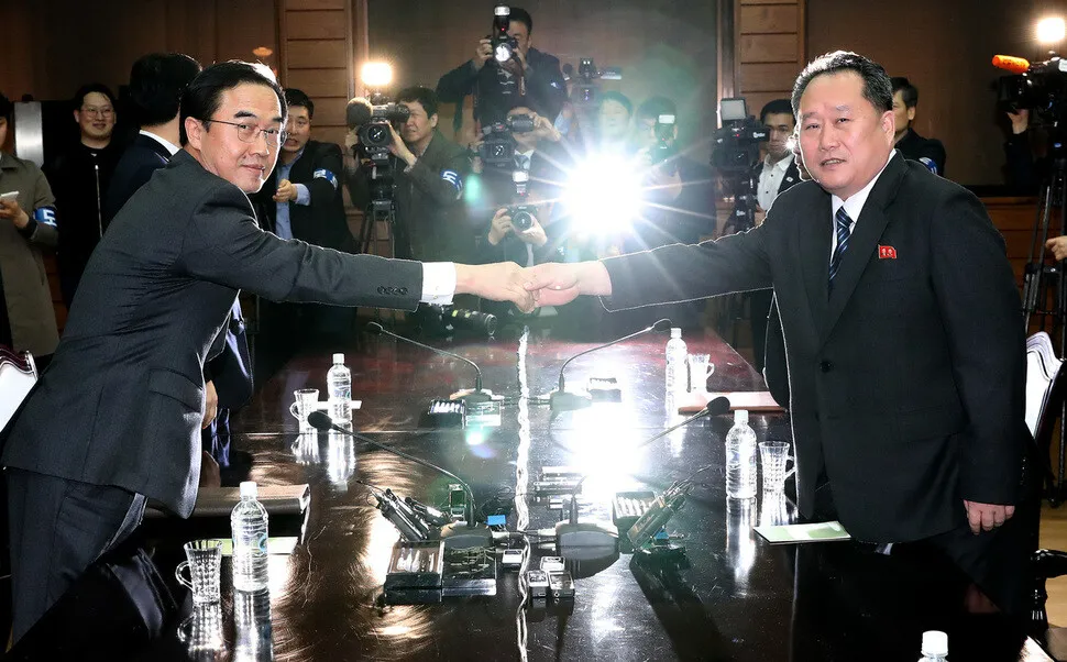 South Korean Unification Minister Cho Myoung-gyon shakes hands with his North Korean counterpart Ri Son-kwon